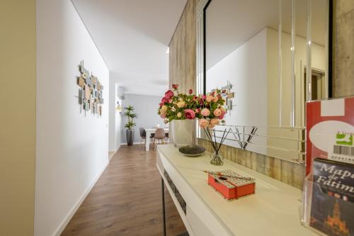 a room with a counter with flowers on it at Alto das Nogueiras House Fátima in Fátima