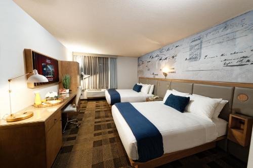 a hotel room with two beds and a television at Silver Sevens Hotel & Casino in Las Vegas