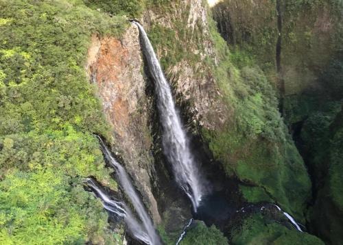 an aerial view of a waterfall on a mountain at T2A Lagon Austral "Jardin du lagon" in Saint-Pierre