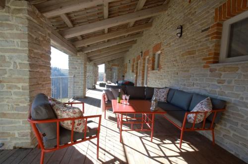a patio with a couch and chairs and a table at Ferrarotti in Clavesana