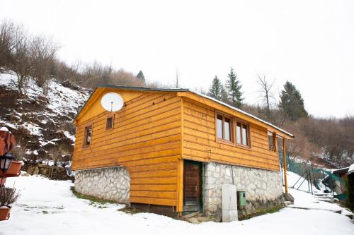 a small wooden house in the snow at Chata Pohoda pri Jánošíku in Terchová