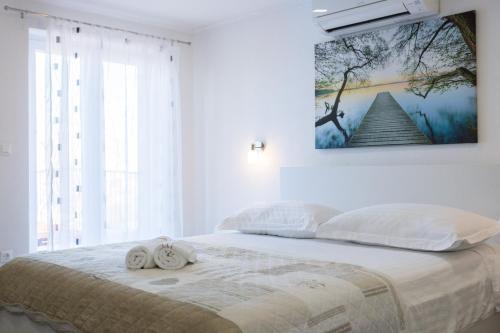 a bedroom with a bed with two towels on it at Sedra Home in Brela
