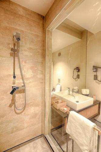 a bathroom with a sink and a shower at Nani Nani Boutique in Braşov