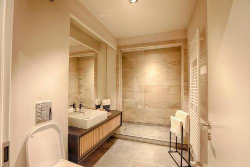 a bathroom with a sink and a toilet and a shower at Nani Nani Boutique in Braşov