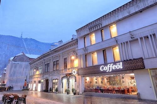 a building with a cotool sign on the side of it at Nani Nani Boutique in Braşov