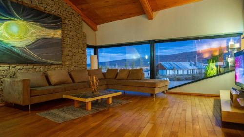 a living room with a couch and a table at Design Suites Calafate in El Calafate