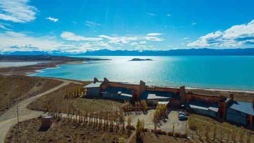 an aerial view of a house next to the water at Design Suites Calafate in El Calafate