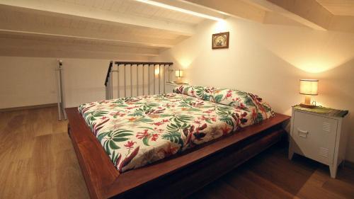 a bedroom with a bed and a night stand with two lamps at casa tre noci in Lascari