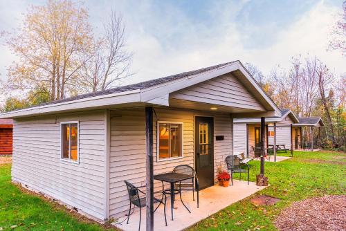 a white tiny house with a table and chairs at Spur of the Moment Ranch in Mountain