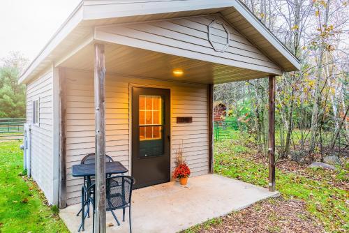 a small house with a porch and a table at Spur of the Moment Ranch in Mountain