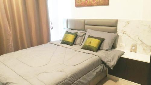 Кровать или кровати в номере The Excel Groove Condo at Lasalle 52
