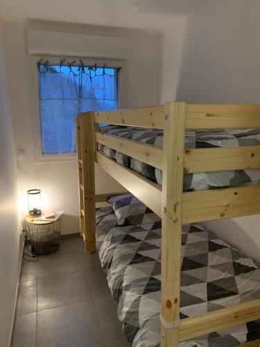 a bedroom with two bunk beds in a room at Les balcons de la haie griselle in Gérardmer