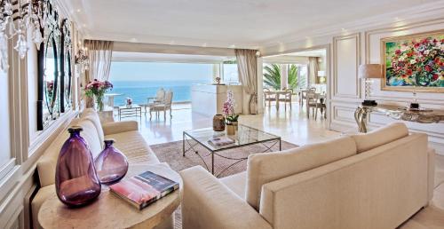 a living room filled with furniture and a table at The Clarendon - Bantry Bay in Cape Town