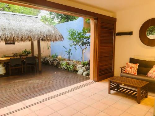 a living room with a large sliding glass door with a table at L'Auberge Noosa in Noosa Heads