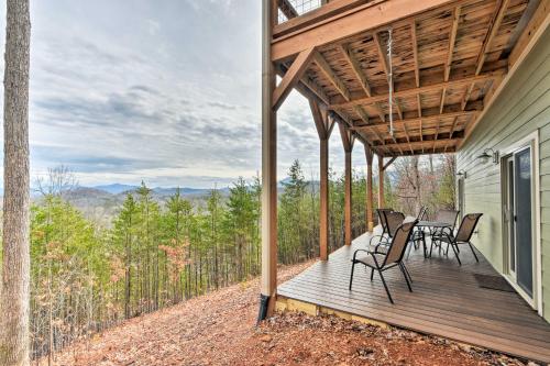 a deck with chairs and tables on a house at Hiawassee Home with Views Less Than 1 Mi to Lake Chatuge in Hiawassee