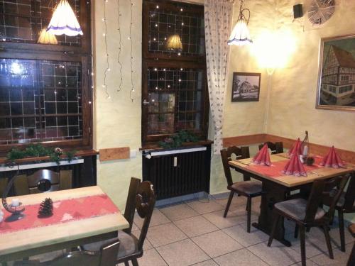 a restaurant with two tables and chairs in a room at Hotel Blaues Haus in Otterberg