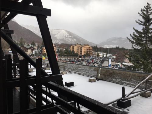 a view from a balcony of a city in the snow at Residence Il Cristallo in Ovindoli