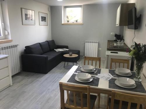 a living room with a table and a couch at Apartment Portorose in Portorož