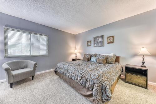 a bedroom with a bed and a chair and a window at Pigeon Forge Paradise in Pigeon Forge