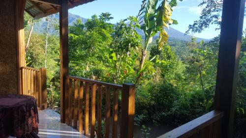 a porch with a view of the mountains at Tetebatu Indah Homestay in Tetebatu