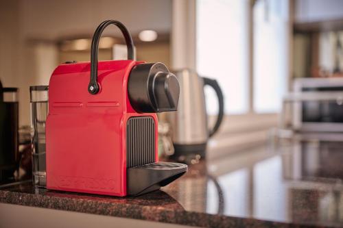 a red suitcase sitting on top of a counter at City Center Apartment with Mountain View in Interlaken