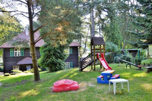 a park with a playground with a slide at Ośrodek Bajka 3 in Łagów