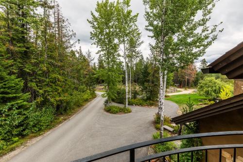 a driveway with trees on the side of a house at Talus Rock Retreat in Sandpoint