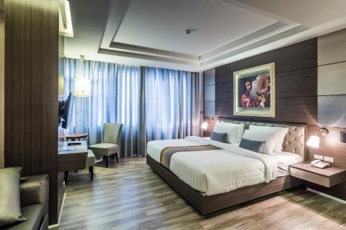 a hotel room with a bed and a desk at Gallery Design - SHA Extra Plus in Si Sa Ket
