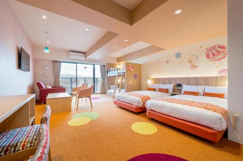 a hotel room with two beds and a desk at RESI STAY Nishijin in Kyoto