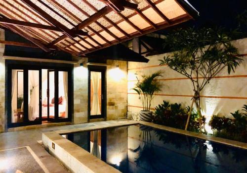 a house with a swimming pool and a building at Kartika Dahayu Private Pool Villas in Sukawati