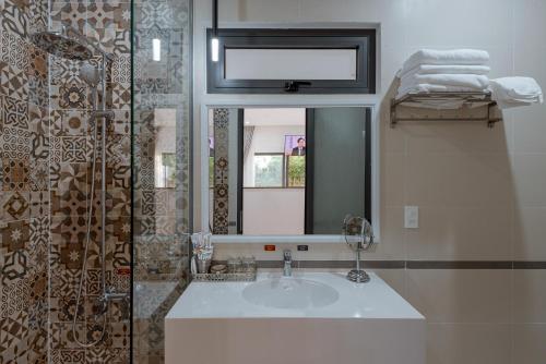 a bathroom with a sink and a mirror at Villa Caribe in Phu Quoc