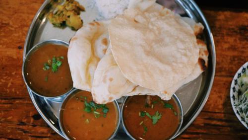 a plate of food with pita bread and soup at WOW STAYZ2 Pachmarhi Foothill Cottages in Pachmarhī