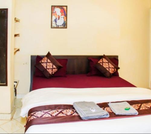 a bed with two towels sitting on top of it at Little Nest in Mandrem