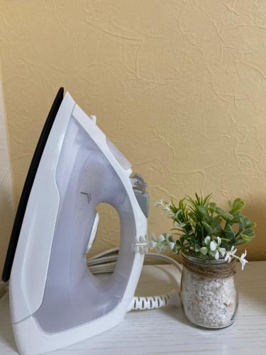 a white toilet sitting on a table next to a plant at La Foret Fujimi in Hiroshima