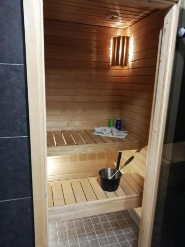 a sauna with a bowl in the middle at Ammatour Apartments in Uro