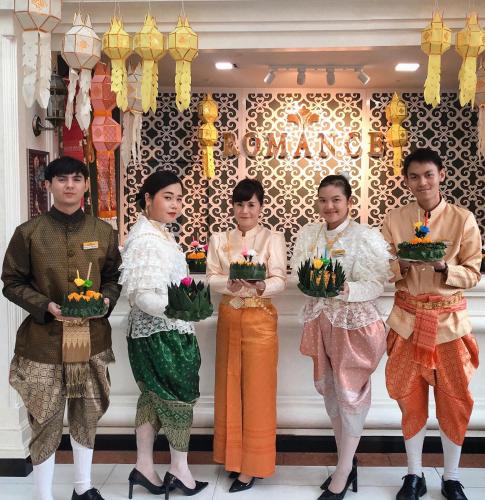 a group of people standing in front of a store at Romance Hotel Sukhumvit 97 in Bangkok