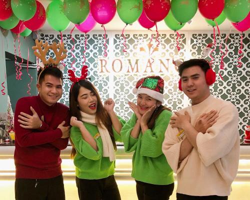 a group of people standing in front of a room with balloons at Romance Hotel Sukhumvit 97 in Bangkok