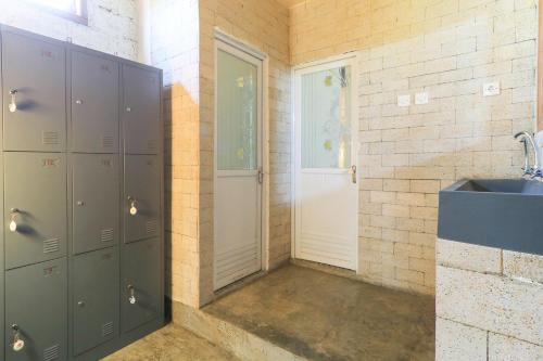 ein Badezimmer mit grauen Schließfächern und einem Waschbecken in der Unterkunft Hostel Bukit Sangcure in Nusa Penida
