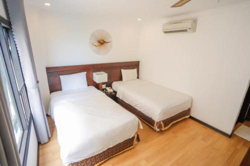Cama ou camas em um quarto em Zenta Hotel