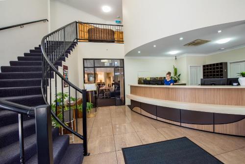 a staircase leading up to a large room with a lot of windows at Coral Cay Resort in Mackay