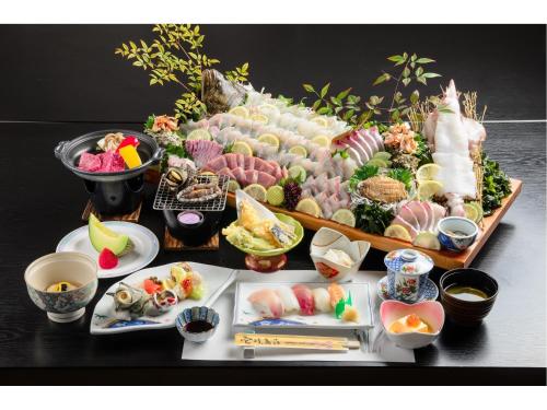 a display of sushi and other food on a table at Ikijimaso in Iki