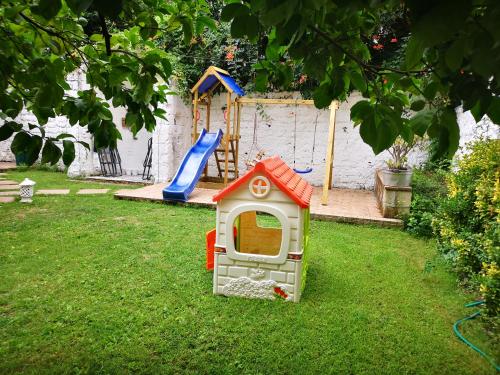 a small dog house in a yard with a playground at The Foria House by House In Naples in Naples