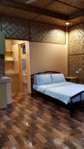 a bedroom with a bed in a room at Paco's Garden Home Stay in Mambajao