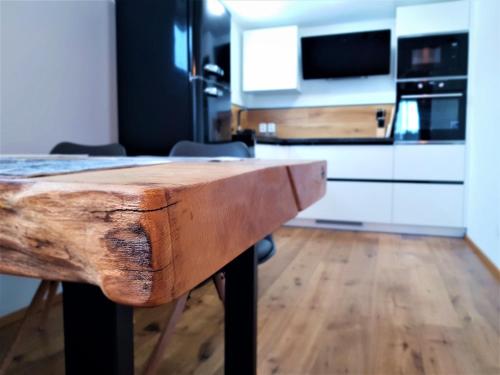 a kitchen with a wooden table in a room at WOODHOME - Luxury Mountain Apartment Horní Malá Úpa in Horní Malá Úpa