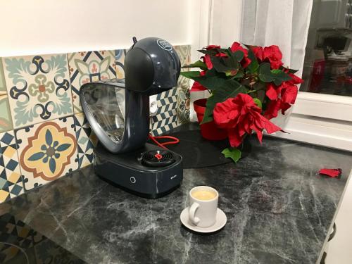 a coffee maker on a counter with a cup of coffee at Cosy Appart Hotel Boulogne -Paris in Boulogne-Billancourt