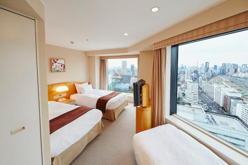 a hotel room with two beds and a large window at Shinagawa Prince Hotel in Tokyo
