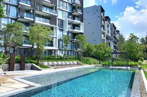 an image of a swimming pool in front of a building at Cassia Residences by Laguna Phuket in Bang Tao Beach