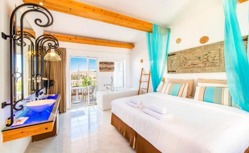 a bedroom with a large bed and a bathroom at Lindos View Hotel in Líndos