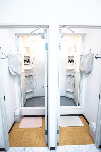 a walk in shower in a bathroom with a mirror at Stay Osaka Namba in Osaka