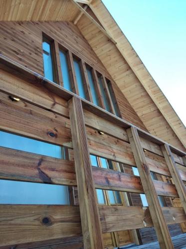 a wooden fence with windows on a building at Kedra Village in Kédra